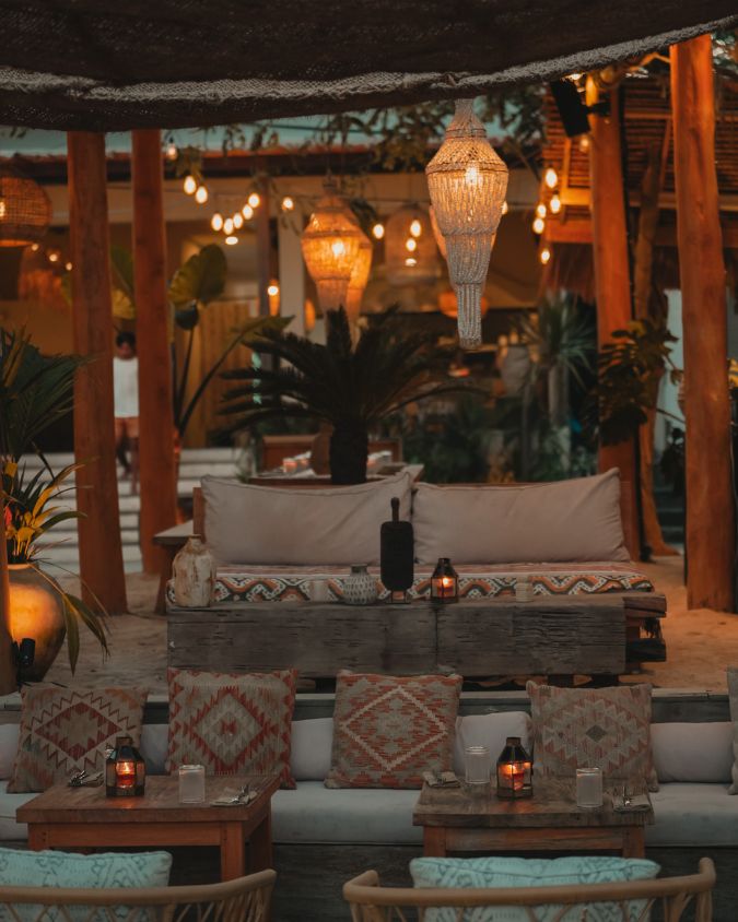 A beautifully lit, cozy lounge and dining area right by the sand at BAHIA Restaurant & Beachbar.